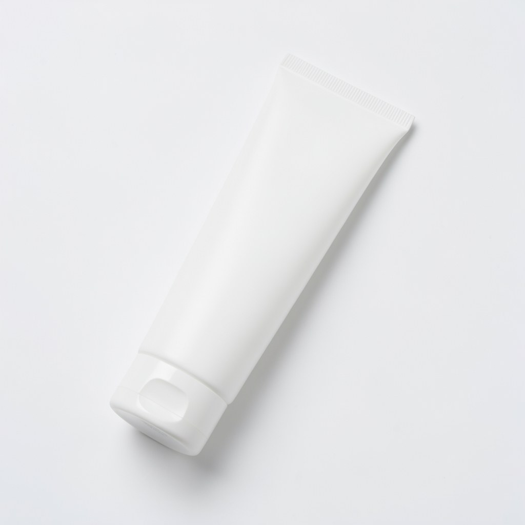 Slim white tube of daily body moisturiser placed diagonally on a plain white background with clean studio lighting from above